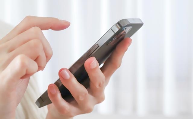 家族葬の港区葬儀社に電話でお問合せしようとしている人の手元。
